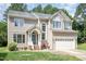 Charming two-story home with inviting entrance, well-manicured lawn, and a two-car garage at 113 Paladin Place, Cary, NC 27513