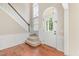 Bright foyer featuring hardwood floors, a staircase with wood trim, and a glass-paned front door at 113 Paladin Place, Cary, NC 27513