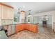 Bright kitchen with stainless steel appliances, tile flooring, and adjacent fireplace and living area at 113 Paladin Place, Cary, NC 27513