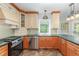 Well-equipped kitchen with custom cabinets, stainless steel appliances, and green countertops at 113 Paladin Place, Cary, NC 27513