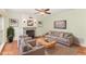 Cozy living room with fireplace, hardwood floors, ceiling fan and neutral colored furniture at 113 Paladin Place, Cary, NC 27513