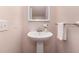 Small powder room with pedestal sink, wall mirror and minimalist decorations at 113 Paladin Place, Cary, NC 27513