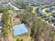 Aerial view of tennis and baseball fields, community amid lush greenery and many single Gathering homes at 1144 Survada Ln, Morrisville, NC 27560