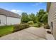 Well-maintained backyard with concrete patio, manicured landscaping, and vibrant greenery for outdoor enjoyment at 1144 Survada Ln, Morrisville, NC 27560