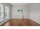 Inviting bedroom with hardwood floors, neutral walls, and a large window at 1144 Survada Ln, Morrisville, NC 27560