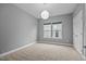 Bedroom with carpet, modern light fixture, neutral walls, and natural light from window at 1144 Survada Ln, Morrisville, NC 27560