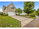 Long driveway leading to the home with a two-car garage and mature trees at 1144 Survada Ln, Morrisville, NC 27560