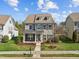 Charming two-story home with a manicured lawn, complemented by black shutters and a welcoming front porch at 1144 Survada Ln, Morrisville, NC 27560