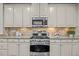 Updated kitchen showcasing stainless steel appliances and sleek cabinetry at 1144 Survada Ln, Morrisville, NC 27560