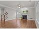 Inviting living room features hardwood floors, a cozy fireplace, and staircase access to the upper level at 1144 Survada Ln, Morrisville, NC 27560
