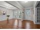 Bright, inviting living room with hardwood floors, wainscoting, and a classic chandelier fixture at 1144 Survada Ln, Morrisville, NC 27560
