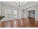 Bright living room featuring hardwood floors, wainscoting, and large windows at 1144 Survada Ln, Morrisville, NC 27560
