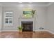 Bright living room with a fireplace and large windows, offering a comfortable gathering space at 1144 Survada Ln, Morrisville, NC 27560