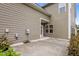 Back patio of home with neutral siding, and door leading indoors at 1144 Survada Ln, Morrisville, NC 27560