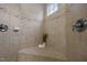 Tiled shower with corner seat, neutral tile, decorative border, and window for natural light at 1144 Survada Ln, Morrisville, NC 27560