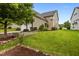 Charming home with lush landscaping, beautiful lawn, and mature trees at 1144 Survada Ln, Morrisville, NC 27560