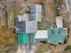 Aerial view of the home featuring multiple rooftops, a large backyard, and greenery at 1146 Rogers Rd, Graham, NC 27253
