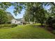 Picturesque backyard with mature trees, offering a serene outdoor escape at 1146 Rogers Rd, Graham, NC 27253