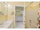 Bathroom with vanity, shower and view to kitchen at 1146 Rogers Rd, Graham, NC 27253