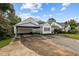 Exterior view showcasing the carport adjacent to the charming home and manicured lawn at 1146 Rogers Rd, Graham, NC 27253