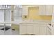 Bright kitchen featuring white cabinets, a sink, and plenty of natural light from the window at 1146 Rogers Rd, Graham, NC 27253