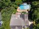 Aerial view of a stunning property showcasing a sparkling pool, lush landscaping, deck, and a well-maintained roof at 121 Flint Point Ln, Holly Springs, NC 27540