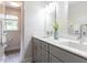 Bathroom featuring double sinks, granite countertops, modern fixtures, and a view to the shower at 121 Flint Point Ln, Holly Springs, NC 27540