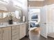 Bathroom with double sink vanity and view into the bedroom at 121 Flint Point Ln, Holly Springs, NC 27540