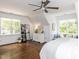 Spacious bedroom with wood floors, lots of windows, and a comfortable sitting area at 121 Flint Point Ln, Holly Springs, NC 27540
