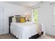 Bright bedroom with a comfortable queen bed, plush pillows, and sun-filled view to the outside at 121 Flint Point Ln, Holly Springs, NC 27540