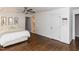 Bedroom featuring hardwood floors, white walls, modern decor and view to the bath at 121 Flint Point Ln, Holly Springs, NC 27540