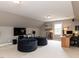 Loft/bonus room featuring a large TV, desk, bean bag chairs, and neutral decor at 121 Flint Point Ln, Holly Springs, NC 27540