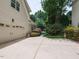Home's exterior highlighting the driveway, garage, manicured landscaping, and a glimpse of the refreshing pool at 121 Flint Point Ln, Holly Springs, NC 27540