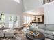 Spacious living room with high ceilings, an open floor plan, and seamless flow to the modern kitchen at 121 Flint Point Ln, Holly Springs, NC 27540