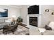 Cozy living room featuring a fireplace with marble surround and a large television at 121 Flint Point Ln, Holly Springs, NC 27540
