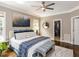Serene main bedroom with a decorative ceiling fan and a walk-in closet at 121 Flint Point Ln, Holly Springs, NC 27540