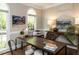 Stylish office with large windows, custom desk, artwork, and hardwood floors, perfect for working from home at 121 Flint Point Ln, Holly Springs, NC 27540