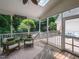 Relaxing screened porch with comfortable seating, overlooking a lush backyard with a swimming pool at 121 Flint Point Ln, Holly Springs, NC 27540