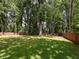 Large backyard is fully fenced, offering privacy and a safe space for outdoor activities and relaxation at 1215 Brookgreen Dr, Cary, NC 27511