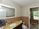 Bathroom with a bright mirror, stylish vanity, tiled walls, and glass-doored shower at 1215 Brookgreen Dr, Cary, NC 27511