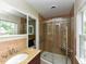 Bathroom with single vanity, toilet, glass shower, tile, and window at 1215 Brookgreen Dr, Cary, NC 27511
