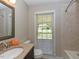 Bathroom features neutral tones, granite vanity, and tiled shower at 1215 Brookgreen Dr, Cary, NC 27511