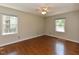 Bright bedroom with hardwood floors, a ceiling fan, and large windows at 1215 Brookgreen Dr, Cary, NC 27511