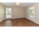 Spacious bedroom with wood flooring and two bright windows providing lots of natural light at 1215 Brookgreen Dr, Cary, NC 27511