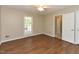 Comfortable bedroom with wood flooring, ceiling fan, and natural light from the window at 1215 Brookgreen Dr, Cary, NC 27511