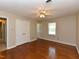 Bedroom with wooden floors, a ceiling fan, two windows, and a double-door closet at 1215 Brookgreen Dr, Cary, NC 27511