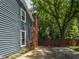 Home's exterior with a brick chimney and partial view of the backyard, showcasing a well-maintained property at 1215 Brookgreen Dr, Cary, NC 27511