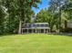 Exterior of charming home with well-maintained lawn and mature trees in a desirable neighborhood setting at 1215 Brookgreen Dr, Cary, NC 27511
