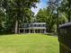 Two-story house with an inviting front porch offers a blend of classic charm and modern comfort at 1215 Brookgreen Dr, Cary, NC 27511