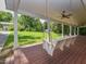 Relax on the covered front porch with its inviting swing, perfect for enjoying the serene outdoor views at 1215 Brookgreen Dr, Cary, NC 27511